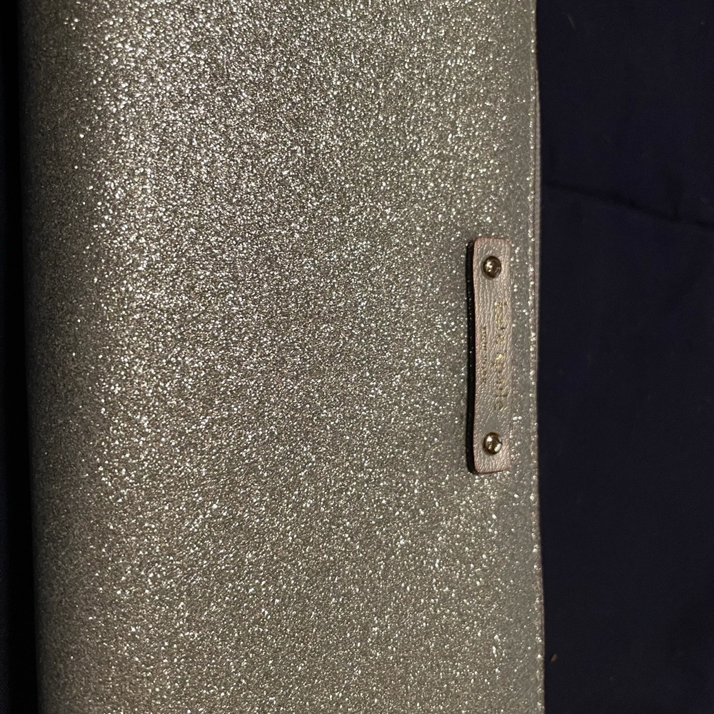 Sparkling silver handheld wallet by Kate Spade